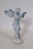 A cast iron garden figure of a fairy holding a bird on her hands, 52cm high