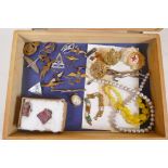 A box of costume jewellery and military badges
