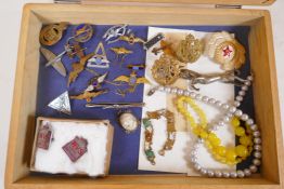 A box of costume jewellery and military badges