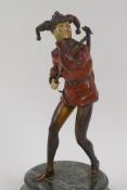A German 1920s cold painted bronze figure of a jester with a lute, standing on a marble socle, 21.
