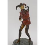 A German 1920s cold painted bronze figure of a jester with a lute, standing on a marble socle, 21.