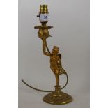 A brass table lamp in the form of a putto bearing a torchere, 24cm high