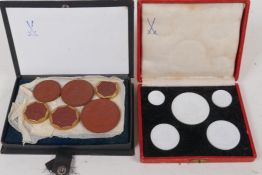 Two boxed sets of Meissen porcelain intaglios of 1920s German coins