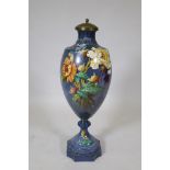 A continental ceramic urn with floral decoration, stamped Bonn, Germany to base, 85cm high