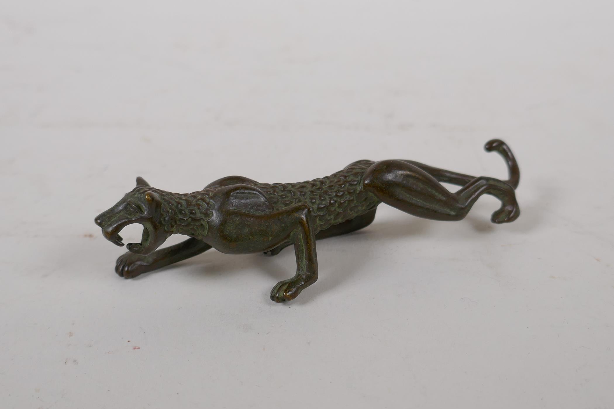 A Japanese style bronze okimono leopard, 11cm long