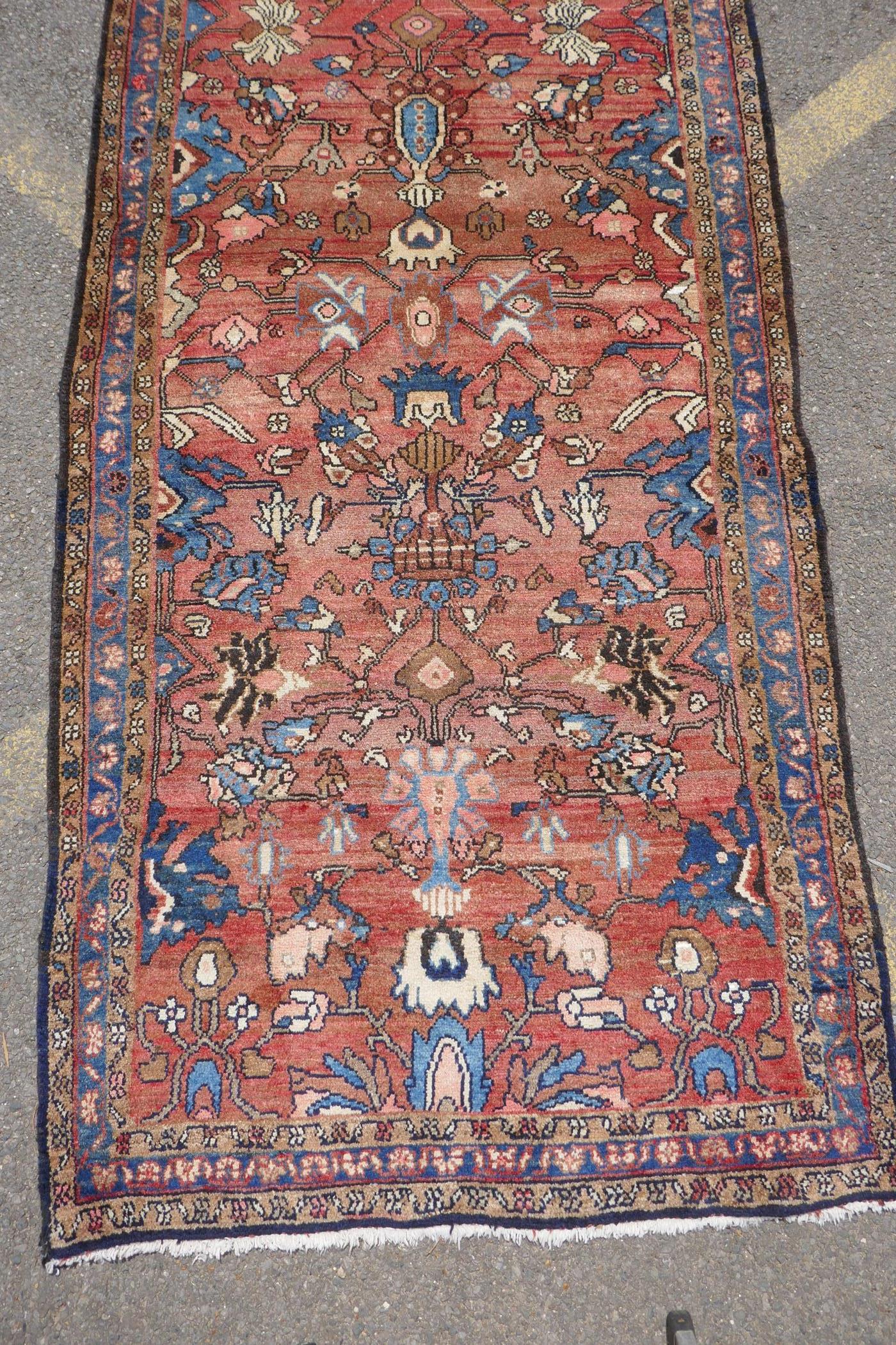 A washed terracotta ground Persian Hamadan runner, with all over floral pattern, 108cm x 284cm - Image 2 of 6