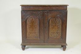 A C19th Anglo Indian padouk side cabinet with brass inlaid decoration, gadrooned edge top over two