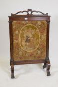 A Victorian inlaid rosewood fire screen with paw feet, fitted with a tapestry depicting a courting