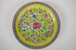A famille jaune porcelain cabinet dish with all over polychrome enamelled floral decoration, Chinese