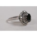 An 18ct white gold dress ring set with a central sapphire encircled by diamonds, approx 3cts, size