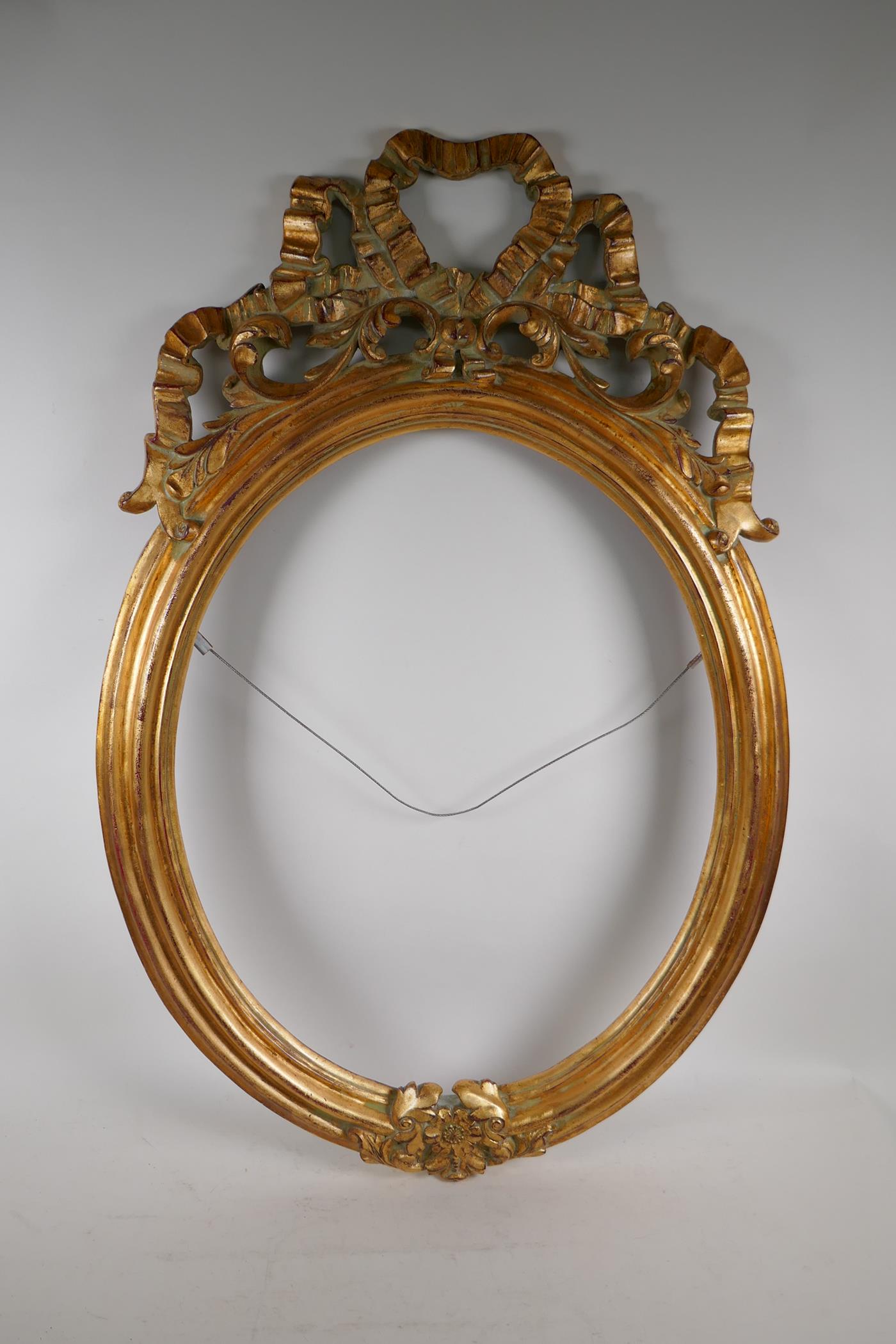 A gilt composition wall mirror, 85cm x 57cm