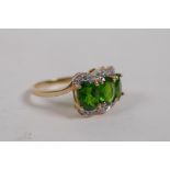 A 10ct yellow gold lady's dress ring set with three oval cut tourmalines and diamonds, size P