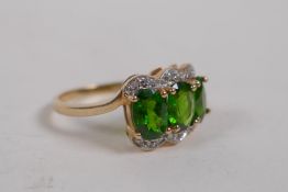 A 10ct yellow gold lady's dress ring set with three oval cut tourmalines and diamonds, size P