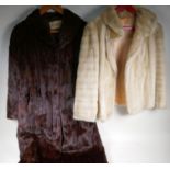 A vintage full length fur coat and a faux fur jacket