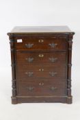 A small oak chest of four drawers flanked by turned columns, raised on a plinth base, late C19th/