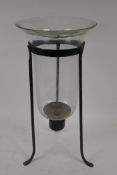 A glass candle lantern in wrought iron stand, 44cm high