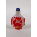 A Peking glass snuff bottle with raised bat, kylin and peach tree decoration, 7cm high