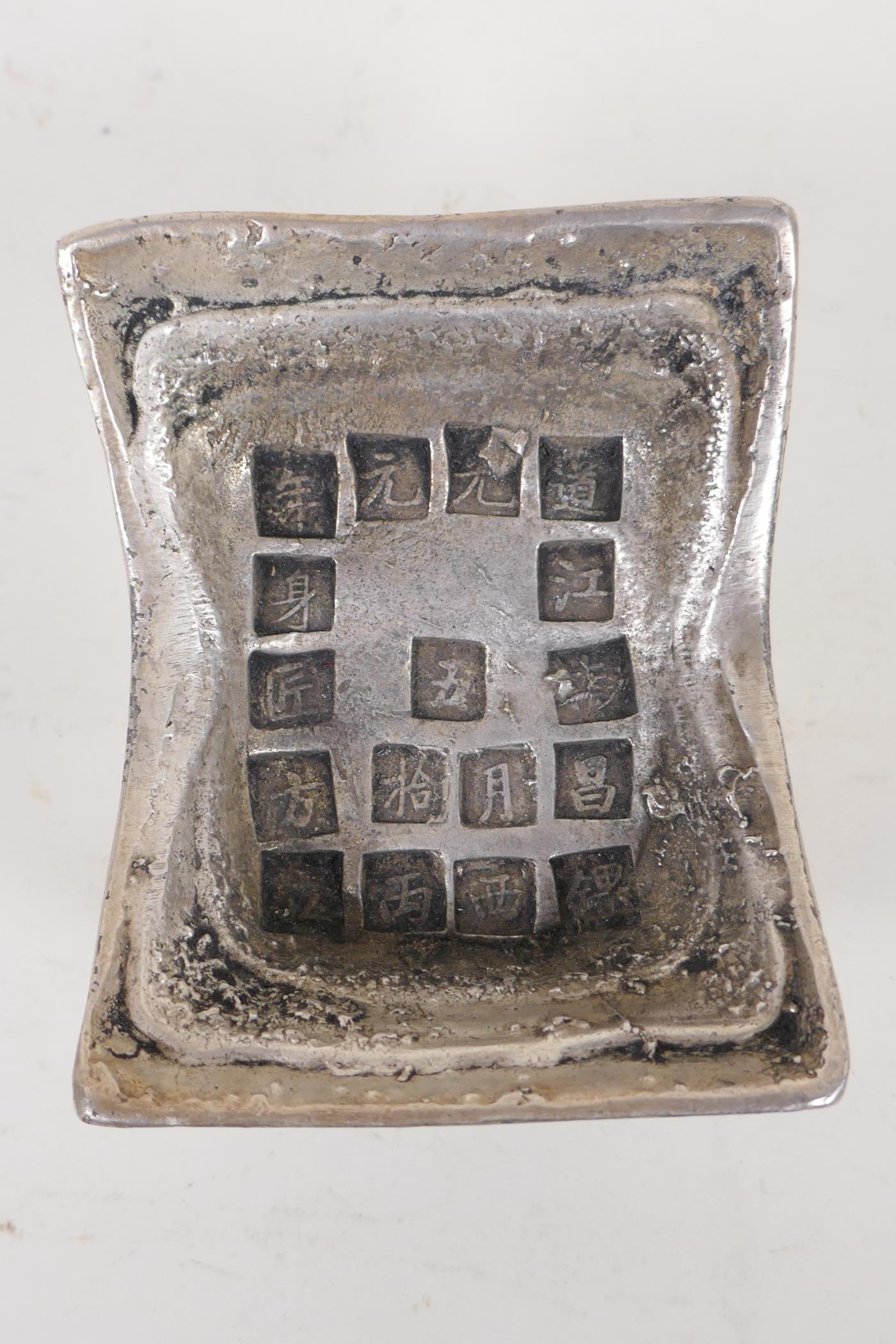 A Chinese white metal trade token/ingot, with impressed character marks, 9cm x 10cm - Image 3 of 3