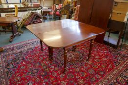 A C19th mahogany dining table of two sections with pull out ends and two extra leaves, 137cm wide