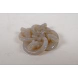A Chinese grey jade pendant carved in the form of entwined dragons, 5cm x 5cm