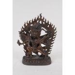 A Sino Tibetan gilt bronze figure depicting the deities Chakrasamvara and Vajravarahi, impressed