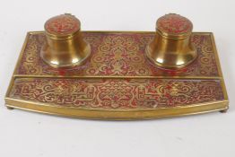 An embossed and lacquered brass boule style desk inkwell, 27cm wide