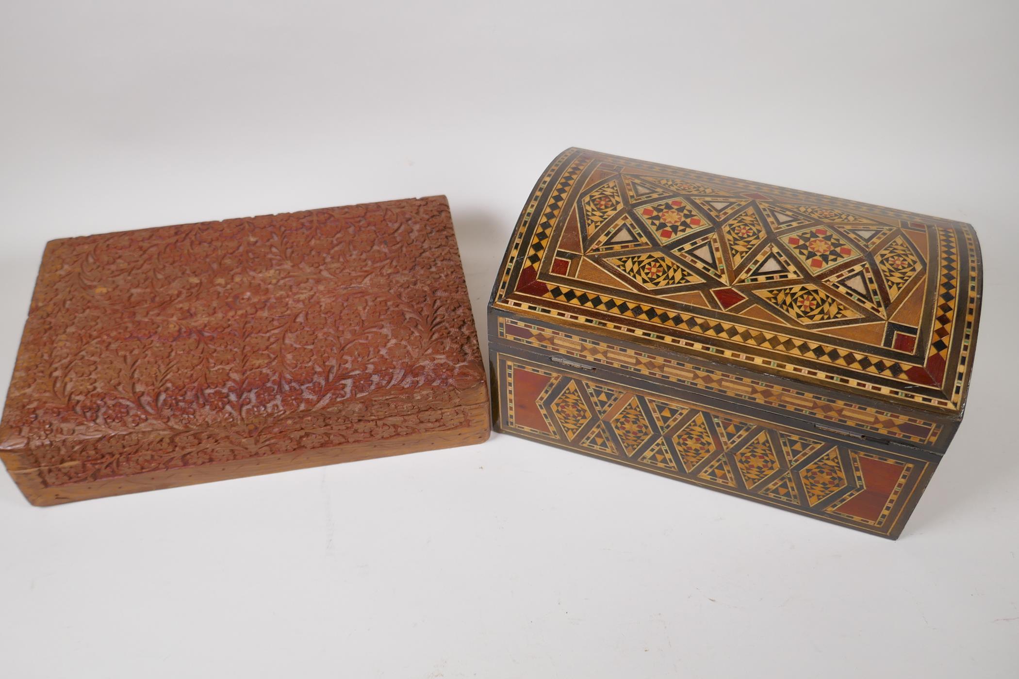 A Damascan inlaid dome top wooden jewellery box, 27cm long, and an extensively carved oriental