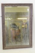 A Victorian wall mirror, the moulded frame with patarae decoration and bevelled glass, 99 x 67cm