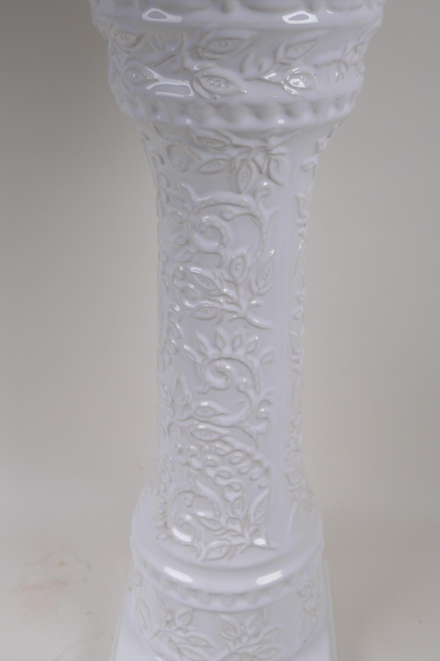 A German white glazed pottery jardiniere on stand with embossed flower and vine decoration, 67cm - Image 2 of 3