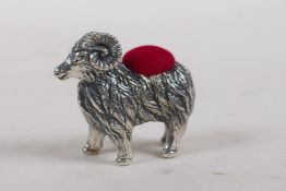 A white metal pincushion in the form of a ram, 4 cm long