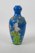 A teal ground porcelain vase with raised and enamelled crane decoration, impressed Chinese