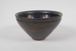 A Chinese Cizhou kiln rice bowl with a spot glaze decoration, marks to base, 13cm diameter