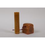 A Chinese amber soapstone cylinder seal with all over character inscriptions, and another, 9cm high