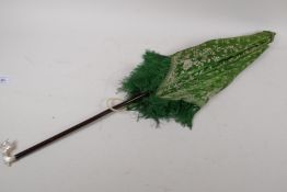 A printed green silk parasol with carved mother of pearl handle, AF tip missing, 72cm long