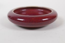 A Chinese flambe glazed pottery ink wash, 10cm diameter