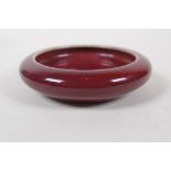 A Chinese flambe glazed pottery ink wash, 10cm diameter