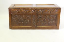 An C18th oak coffer with two carved panels and frieze and panelled top, 116 x 49 x 52cm