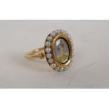 An early C19th high carat gold ring set with seed pearls and a miniature portrait of a lady, size L