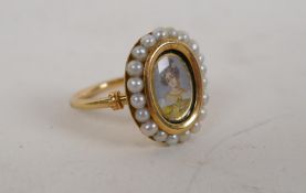 An early C19th high carat gold ring set with seed pearls and a miniature portrait of a lady, size L