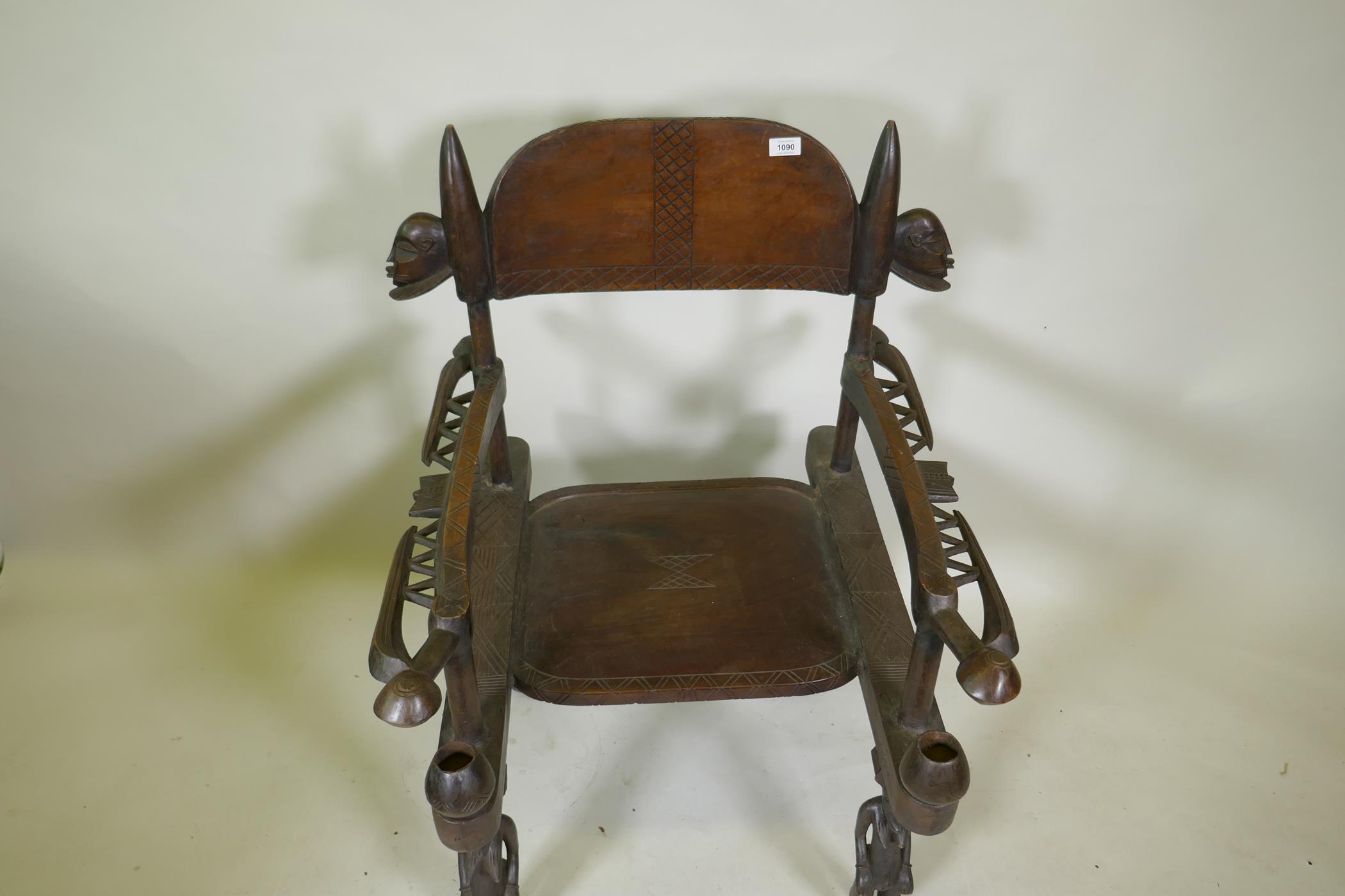 An African carved wood throne chair decorated with masks and geometric patterns, the legs carved - Image 3 of 4