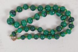 A string of graduated malachite beads, with 9ct gold clasp