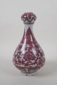 A Chinese red and white porcelain garlic head shape vase with scrolling lotus flower decoration,