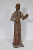 An antique carved and painted soft wood figure of a saint, 104cm high