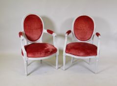A pair of C19th French armchairs, with spoon backs and shaped fronts, raised on tapering fluted