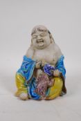A Chinese Sancai glazed porcelain Lohan figure, 17cm high