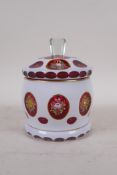 A C19th Bohemian overlaid ruby glass jar and cover with gilt and enamel decoration, AF cover