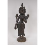 An antique bronze figure of Shiva, standing upon a dais, 50cm high