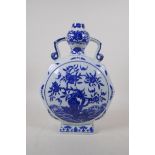 A blue and white porcelain two handled garlic head shaped moon flask decorated with a fruiting peach