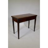 A late C18th/early C19th mahogany tea table, with fold over top, raised on moulded tapering