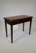 A late C18th/early C19th mahogany tea table, with fold over top, raised on moulded tapering